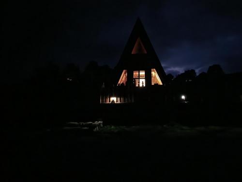 a church at night with its lights on at A Pine vikendica u srcu Zapadne Srbije in Nova Varoš
