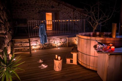 a room with a hot tub and a table with candles at Gites de l'alouette in Boffres