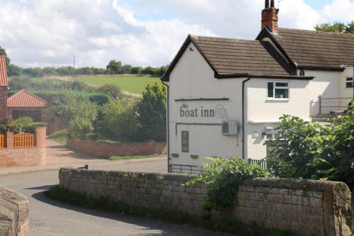 a white building with the words boat inn on it at The Boat Inn Hayton in Retford