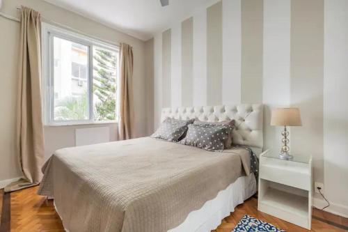 a bedroom with a large bed and a window at Apartamento Epitácio Pessoa in Rio de Janeiro