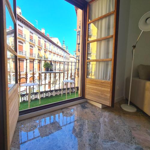 a room with a window and a view of a city at Dos Torres Exclusivos en Calle Alfonso I in Zaragoza