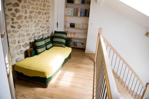 a living room with a couch and a staircase at Gites de l'alouette in Boffres