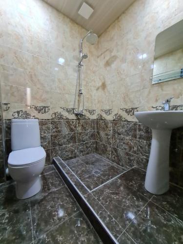 a bathroom with a toilet and a sink at Gricko in Tbilisi City