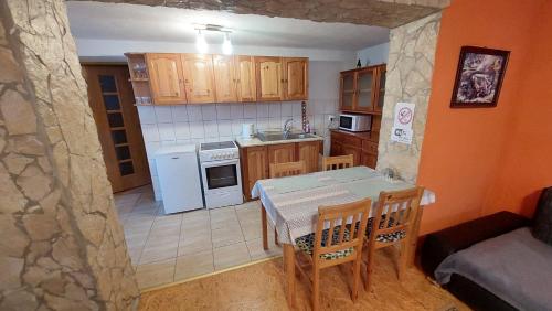 a kitchen with a table and chairs in a room at Privat 498 in Lúčky
