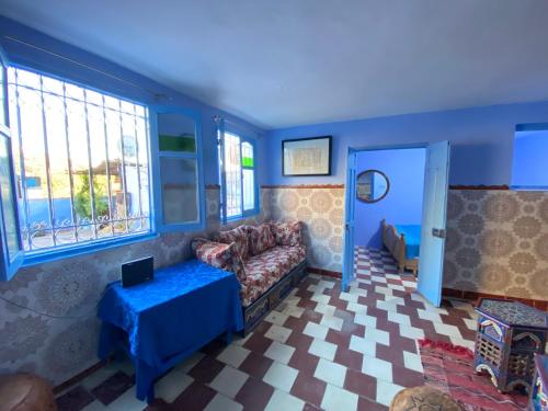 a living room with a couch and a table at Dar Lazrak in Chefchaouene