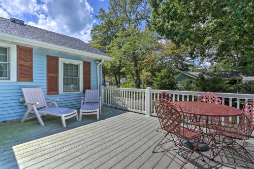 a wooden deck with a table and chairs on a house at Dog-Friendly Waretown Home with Furnished Deck! in Waretown