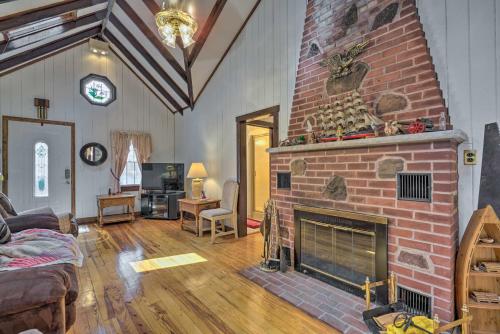 a living room with a brick fireplace at Dog-Friendly Waretown Home with Furnished Deck! in Waretown