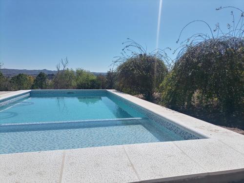 a swimming pool sitting on the side of a house at Cabañas Akumali in Nono