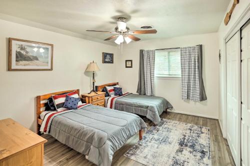 a bedroom with two beds and a ceiling fan at Fort Worth Retreat with Fenced Yard and Fire Pit! in Fort Worth