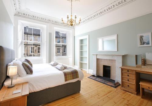 a bedroom with a bed and a fireplace at The Newington Residence in Edinburgh