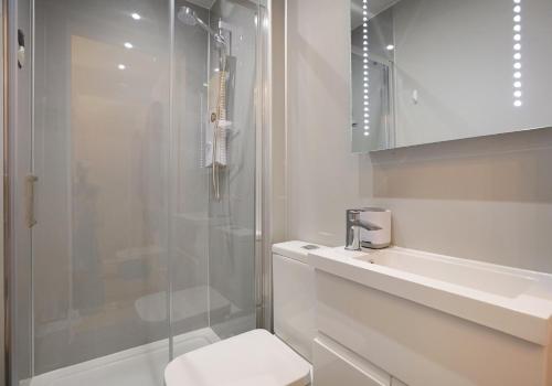 a bathroom with a shower and a toilet and a sink at The Newington Residence in Edinburgh