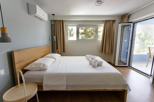a bedroom with a large bed with towels on it at Analipseos 9 Loft in Kalamata