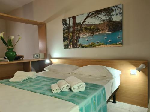 Llit o llits en una habitació de Hotel La Buca Del Gatto