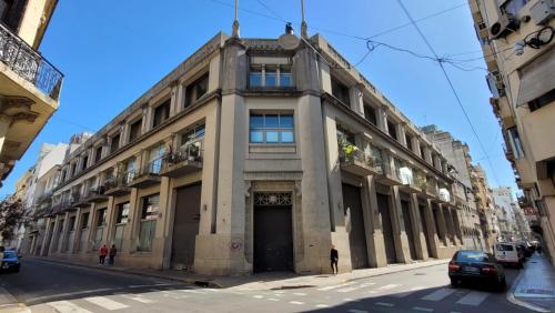 an old building on a street in a city at Vivaterra Apartments - San Telmo in Buenos Aires