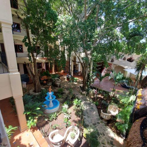 an aerial view of a garden with a blue fountain at Hotel Nojoch che in Cobá