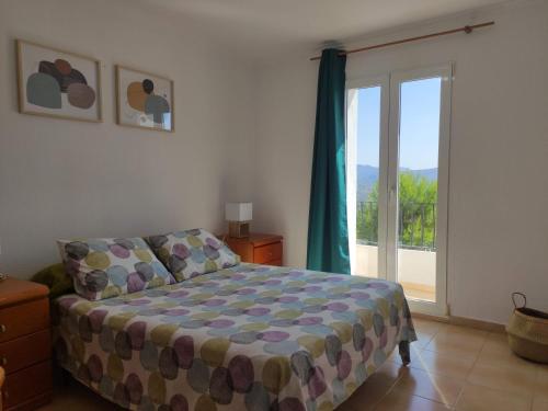 sypialnia z łóżkiem i przesuwnymi szklanymi drzwiami w obiekcie Apartamento rural Casa Calo 
