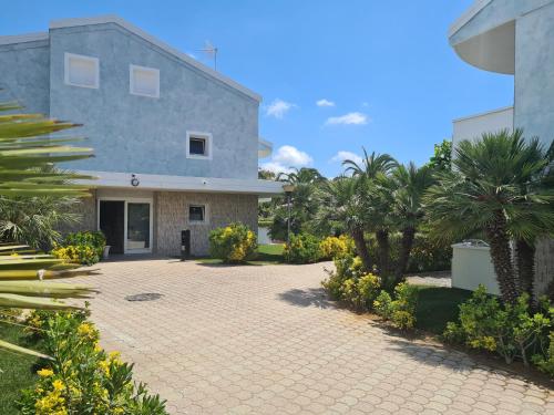 a house with a driveway in front of it at Hotel La Buca Del Gatto in Marina di Cecina