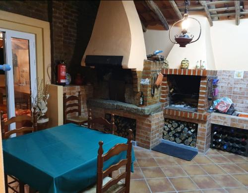 a living room with a brick fireplace and a table at Quinta Lameira do Vale in Fundão