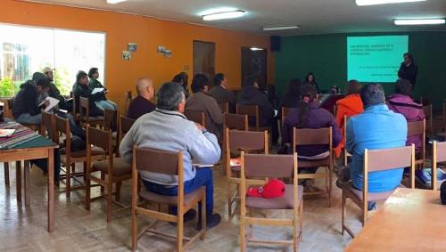 a group of people sitting in chairs in a room at Hotel Las Vicuñas in Putre