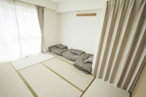 a room with two beds in a room with a window at Bios Hall / Vacation STAY 2181 in Sapporo