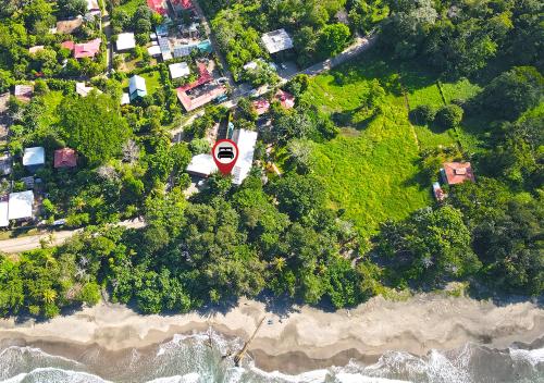 an aerial view of a beach with a house and the ocean at Hotel Banana Azul - Adults Only in Puerto Viejo