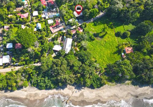 an overhead view of a beach with trees and the ocean at Hotel Banana Azul - Adults Only in Puerto Viejo