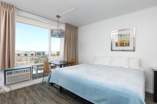 a hotel room with a bed and a window at Olympic Island Beach Resort in Wildwood Crest