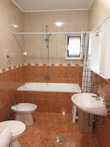 een badkamer met een bad, een toilet en een wastafel bij Apartment Luka near Dubrovnik in Čibača