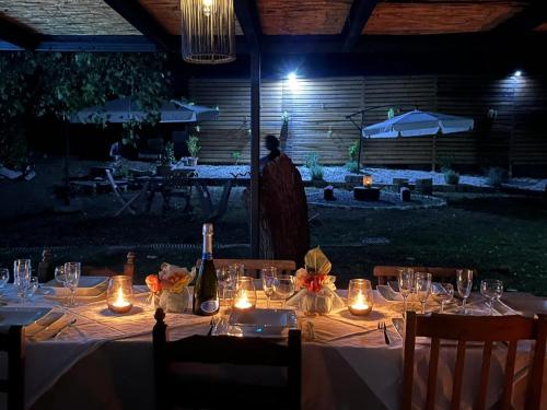 a table with candles and bottles of wine on it at La cà di anna in Polverara