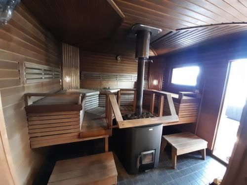 an inside view of a sauna with a stove at Mökki ja rantasauna Saimaan rannalla in Taipalsaari