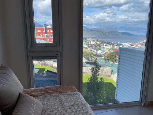 a bedroom with a window with a view of a city at Infinity View 3-4 in Ushuaia