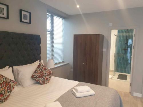 a bedroom with a bed with two towels on it at M-Hotels Apartments in London