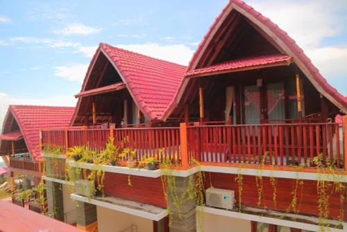 a building with a red roof with plants on it at Ayu Laba Beach Villa and Resto in Nusa Penida