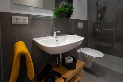 a bathroom with a sink and a toilet at Livin63 Studio Apartments in Hösbach