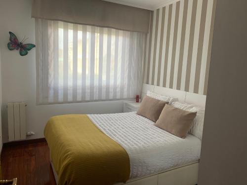 a bedroom with a bed with a butterfly on the window at Apartamento Conchita in Vigo