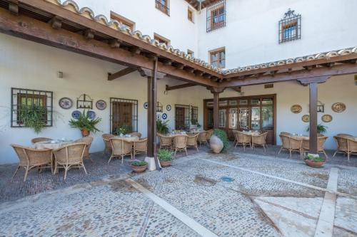 a courtyard with tables and chairs in a building at Condesa de Chinchón in Chinchón