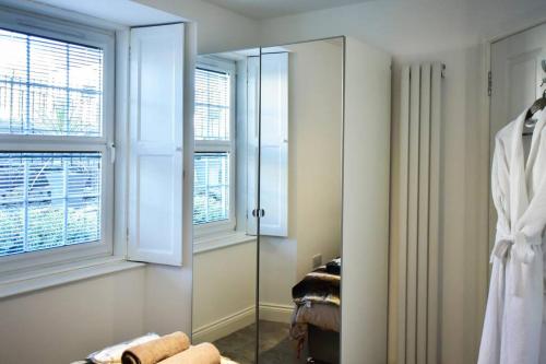 a dressing room with a mirror and a window at Hot Tub Apartment at Pirn Road in Innerleithen