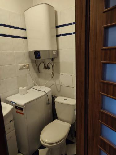 a small bathroom with a toilet and a light at Apartment in the center of Krakow in Kraków