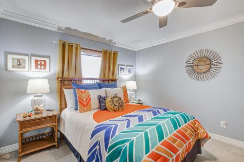 a bedroom with a bed and a ceiling fan at Summer Getaway Specials! Front Row Views - Tiki Bar - Playground - Fenced Yard in Bolivar Peninsula