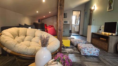 a living room with a white couch and a vase on a table at River Hills Guest House in Lesichevo