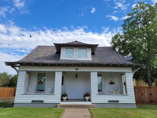 a white house with a brown roof at Holland House - Historic and Sophisticated in Alpine