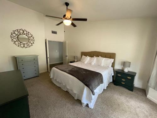 um quarto com uma cama e uma ventoinha de tecto em Vista Retreat - Country Club Estates em Sierra Vista