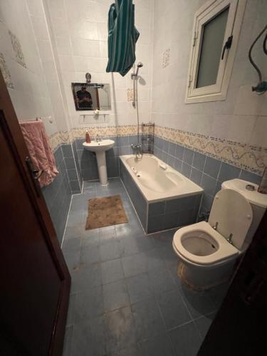 a bathroom with a toilet and a tub and a sink at Morning Star Guesthouse in Sharm El Sheikh