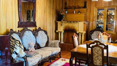 a living room with two chairs and a couch and a table at Belas House With Terrace in Kutaisi