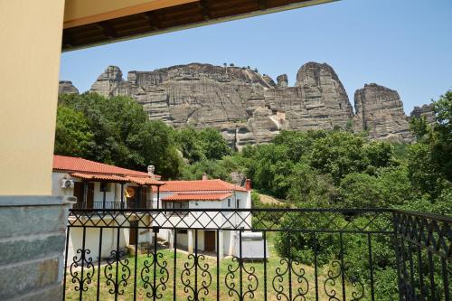 a view from a balcony of a building with rock formations at Guesthouse Papastathis in Kalabaka