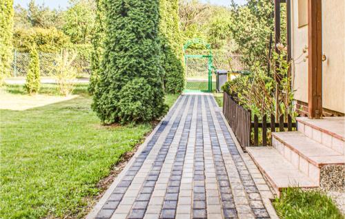 a brick walkway in a yard next to a house at Stunning Home In Golubie With Wifi in Gołubie