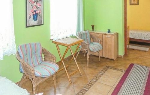 a living room with two chairs and a table at Nice Home In Pl-76-113 Postomino in Korlino