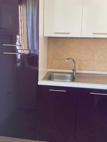 a kitchen with black cabinets and a sink at Residenza Guarna in Salerno