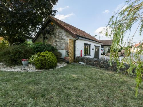 a small stone house with a yard at The Forge in Taunton