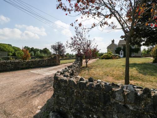 a stone wall in front of a house at The Forge in Taunton
